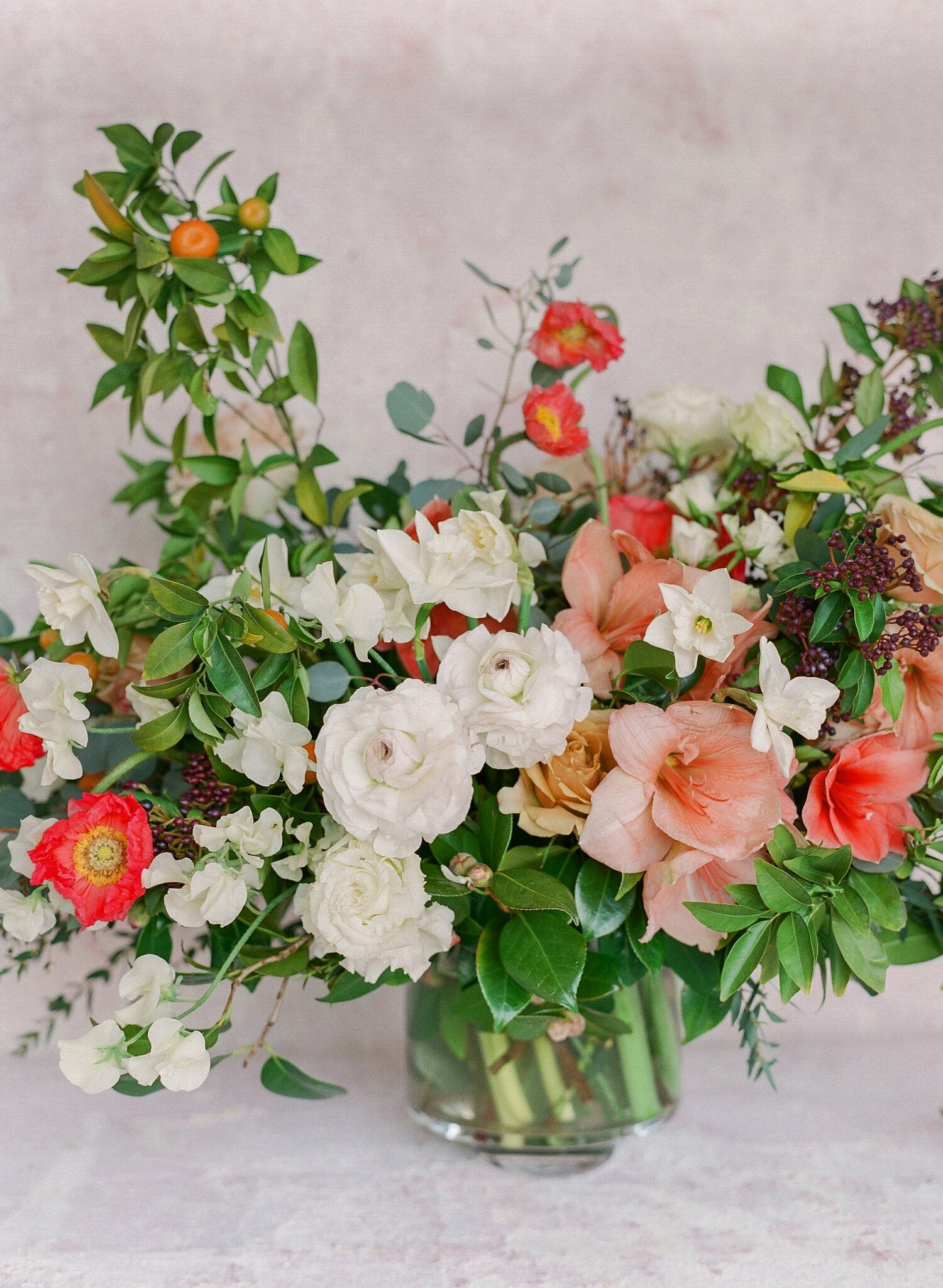 Large seasonal bouquet with red, white, pink flowers and greenery.
