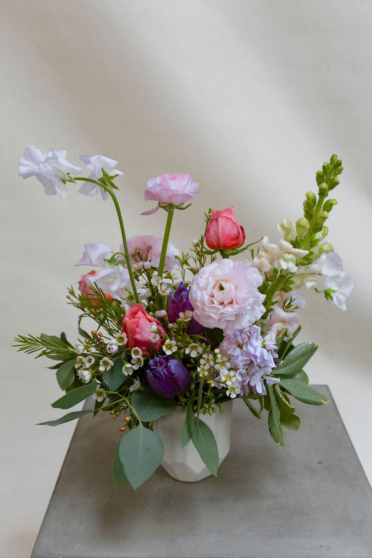 Small bouquet with white, pink, and purple flowers.