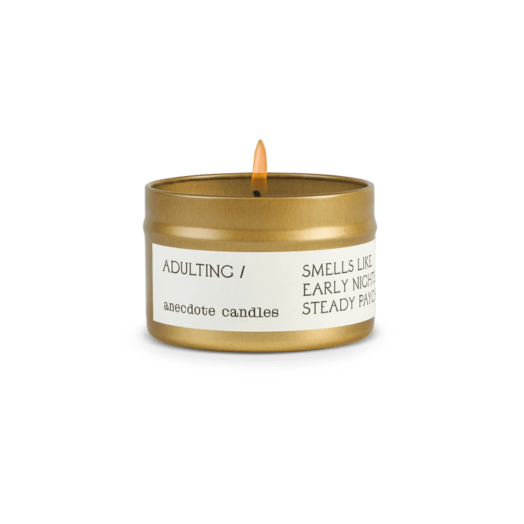 Small Anecdote candle in gold packaging with label reading Adulting.