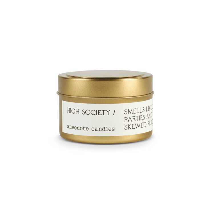 Small gold Anecdote candle with label reading High Society.