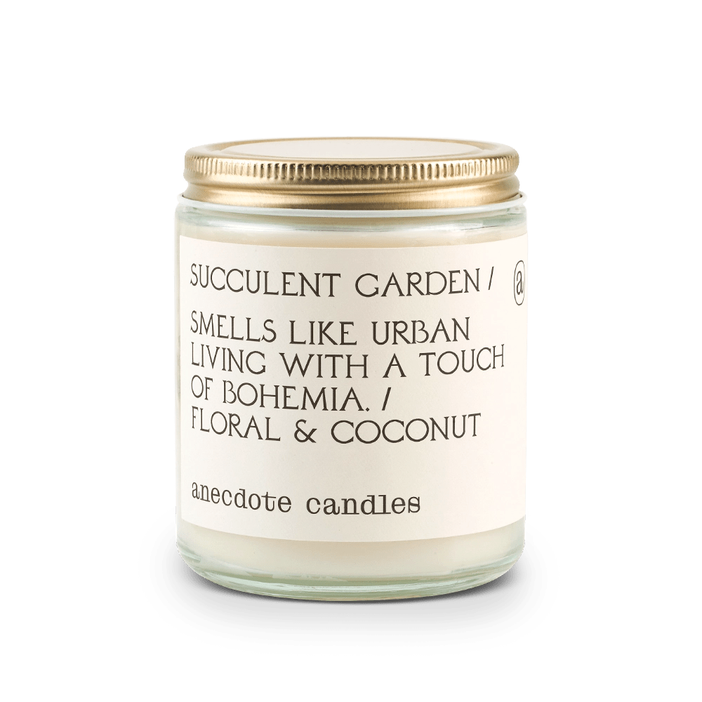 Candle with label that reads Succulent Garden / Smells like urban living with a touch of bohemia. / Floral and coconut.